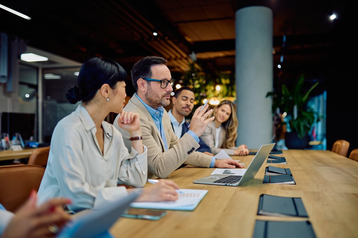 Business professionals discussing investment strategy in a meeting