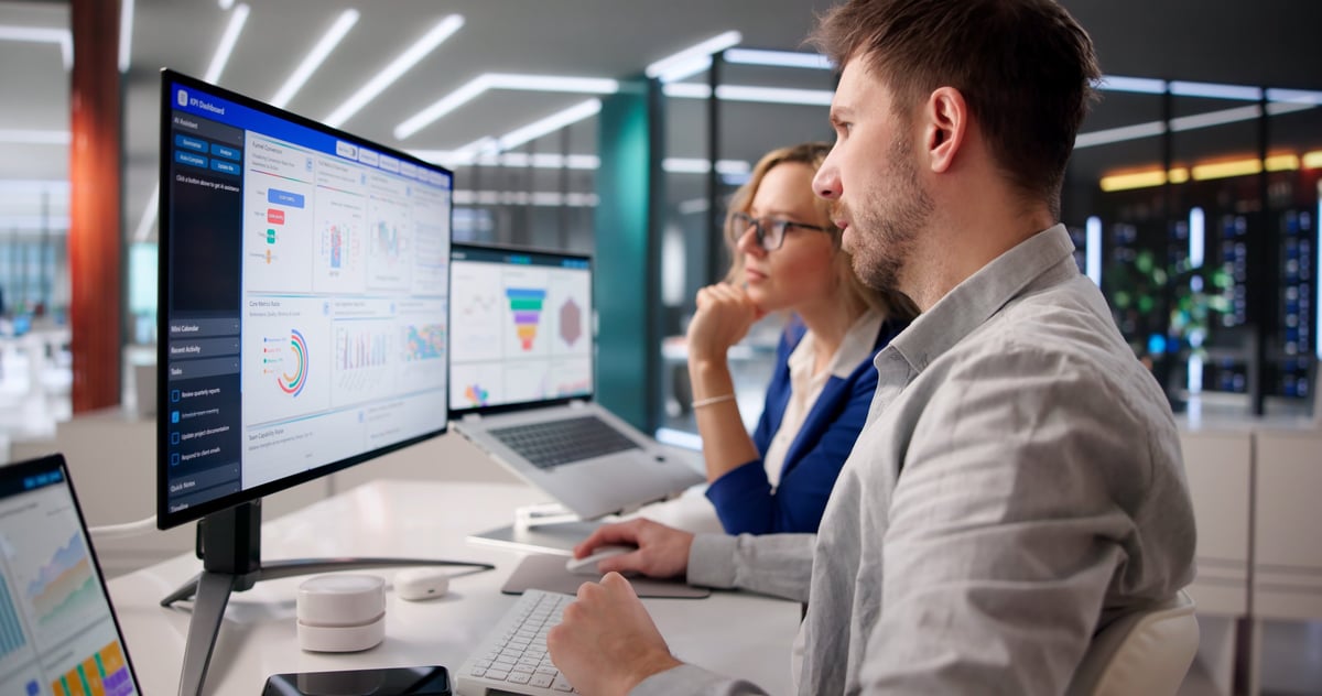 Business professionals analyzing procurement dashboards and data for government contracting decisions
